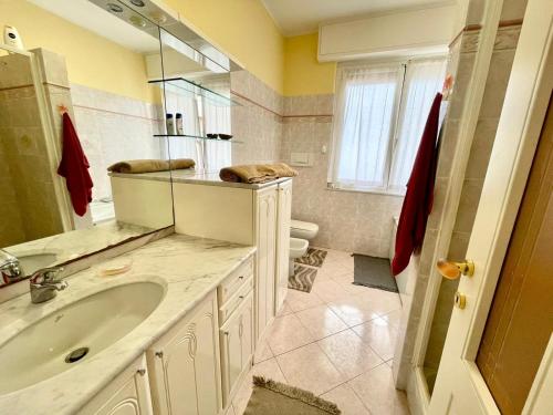 a bathroom with a sink and a mirror at Casa Conchiglia in Vado Ligure