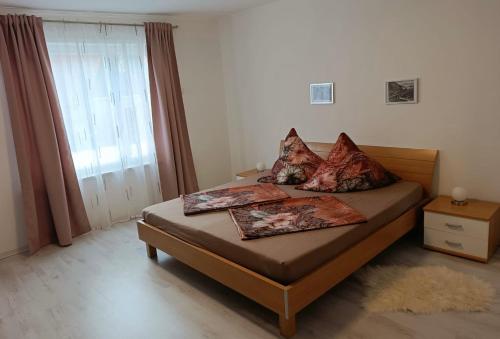 a bedroom with a bed with two pillows on it at Ferienhaus Rübeland in Neuwerk