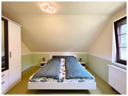 a bedroom with a bed and two night stands at Haus schöne Aussicht bei Chemnitz in Chemnitz