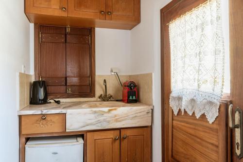 a small kitchen with a sink and a window at Casa Tradizionale Monemvasia in Monemvasia