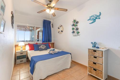 a bedroom with a bed and a ceiling fan at Seaside House With Heated Pool in Pájara