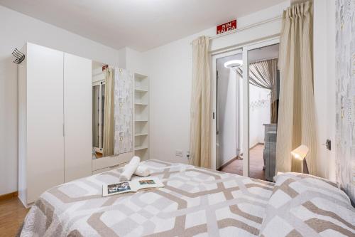 a bedroom with a bed with a book on it at Ágora Alhambra in Atarfe