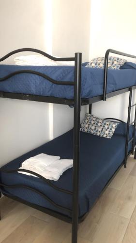a couple of bunk beds in a room at Casa Nessi- Stanze in Platamona