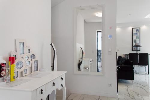 a white bathroom with a sink and a mirror at Luxusvilla Neubau 2 in Oberasbach