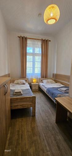 a bedroom with two beds and a window at Ośrodek Wypoczynkowy Radosno in Sokołowsko