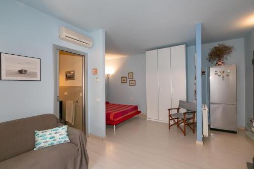 a living room with a couch and a refrigerator at Residence Valle Fiorita in Piombino