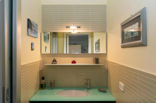 a bathroom with a sink and a mirror at Residence Valle Fiorita in Piombino