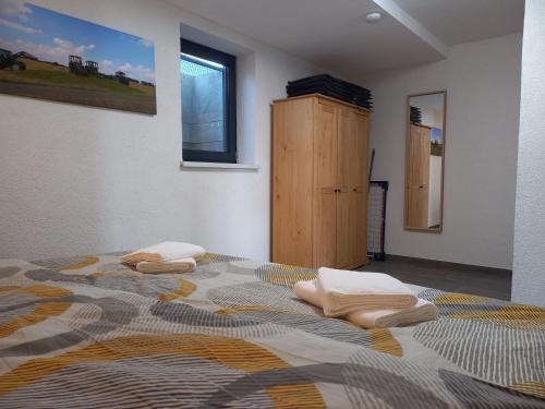 a bedroom with a bed with two pillows on it at Bauernhof Schäfer in Mühlacker