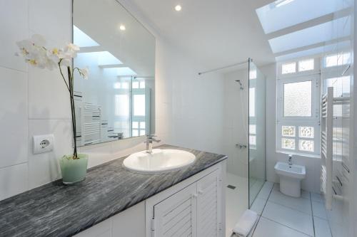 a white bathroom with a sink and a toilet at Can Lluc in Nuestra Señora de Jesus