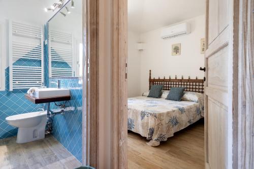 a bathroom with a bed and a sink in a room at Villa Amata in Arzachena