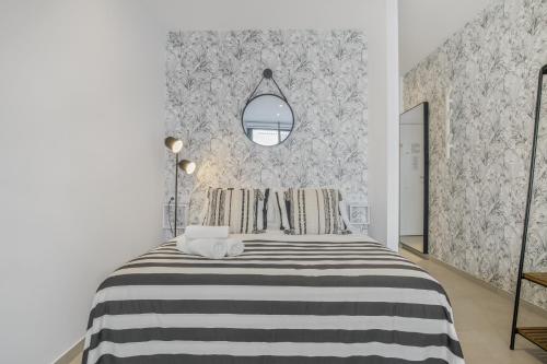 a bedroom with a black and white striped bed at Apartamento Black and White 1 11 in Tarifa