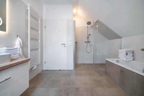a white bathroom with a shower and a sink at Seeglück 1 am Tollensesee in Groß Nemerow