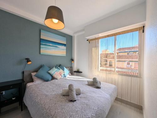 a bedroom with a bed with two stuffed animals on it at R-23 Modern apartment in La Mata in La Mata