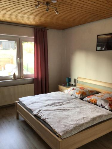 a bedroom with a bed and a window at Balver Aussicht in Balve