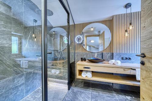 a bathroom with a shower and a sink and a mirror at Chalet Schlossberg Schlern in Nova Ponente