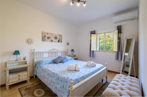 a bedroom with a bed and a window at Villa Grazia in Gallipoli
