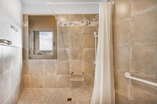 a bathroom with a shower with a shower curtain at El Paller de Cal Maso in Guisona