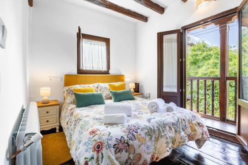 a bedroom with a bed and a large window at Casa Raymonde in Potes