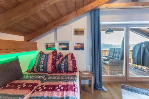 a bedroom with a bed with colorful pillows at Ferienwohnung Parzinger in Chieming