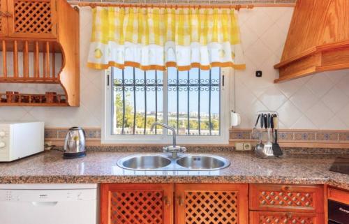 a kitchen counter with a sink and a window at Casa El Retiro in Nerja