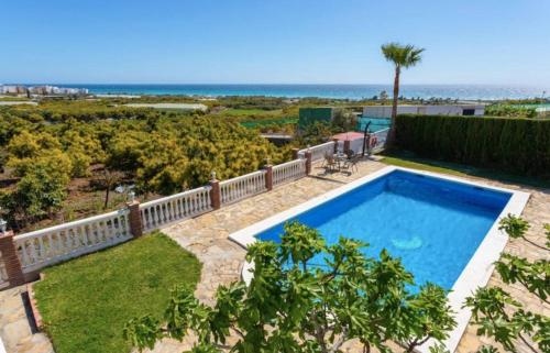 a swimming pool with a view of the ocean at Casa El Retiro in Nerja