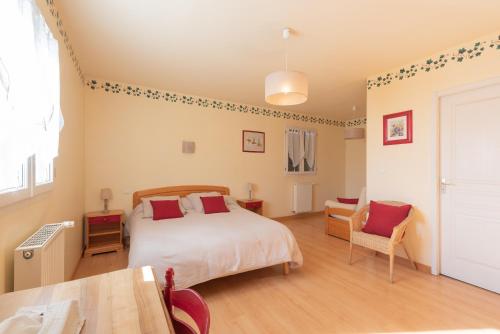 a bedroom with a bed and a table and chairs at Gite Le Bérierot avec piscine in Ouzous