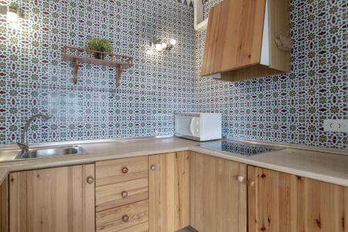 a kitchen with a sink and a counter top at Complejo Alejandra in Conil de la Frontera