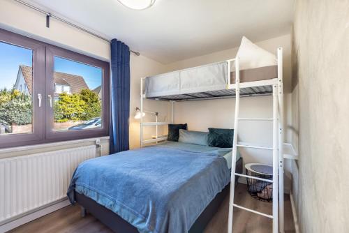a bedroom with a bunk bed and a window at Ostseekind in Timmendorfer Strand