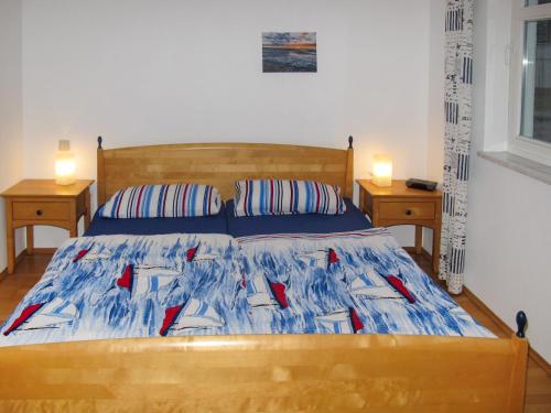 a bedroom with a bed with two night stands at Apartment Juliusruh-3 by Interhome in Juliusruh