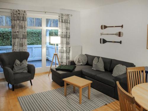 a living room with a couch and a table at Apartment Juliusruh-3 by Interhome in Juliusruh