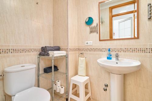 a bathroom with a toilet and a sink and a mirror at Apartamento B y G Nerja in Nerja