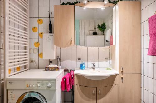 a bathroom with a washing machine and a sink at Haus Leufke in Lenzkirch