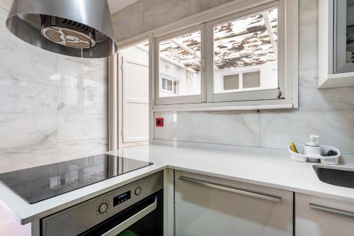 a kitchen with a sink and a stove at San Antonio in Sedaví
