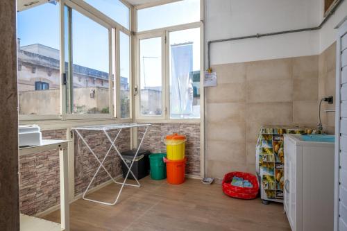 a kitchen with windows and a counter with a dishwasher at Casa Ester in Francavilla Fontana
