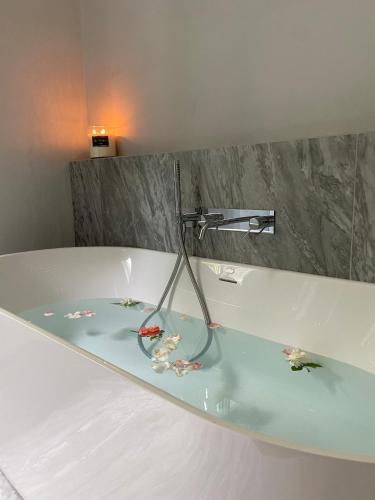 a bath tub with a lamp on top of it at Villa Brecht in Bagni di Lucca