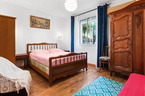a bedroom with a large bed and a window at Villa Sauvageonne in Saint-Raphaël