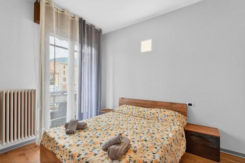 a bedroom with a bed and a large window at Casa Sandrina in Caprino Veronese
