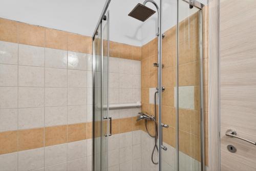 a shower with a glass door in a bathroom at Casa Sandrina in Caprino Veronese