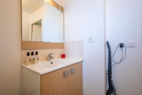 a bathroom with a sink and a mirror at T3 au calme avec terrasse in Cogolin