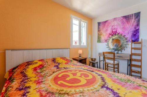 a bedroom with a bed with a colorful bedspread at T3 au calme avec terrasse in Cogolin