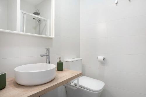 a white bathroom with a sink and a toilet at Casa Lavanda Vejer in La Muela