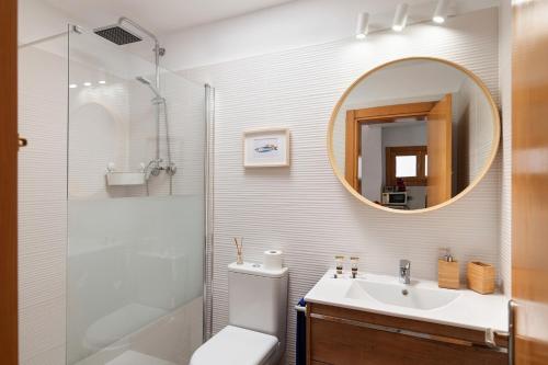 a bathroom with a toilet and a sink and a mirror at La Mariana in Punta Mujeres