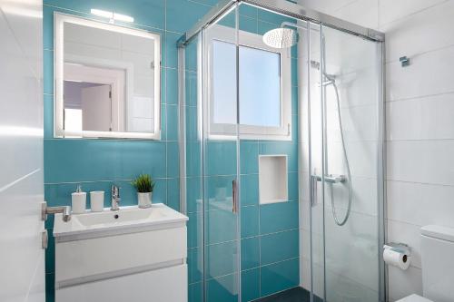 a bathroom with a sink and a glass shower at Ocean 1 in La Santa