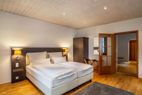 a bedroom with a large white bed in a room at Luise in Bad Bergzabern