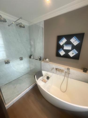 a bathroom with a bath tub and a shower at 51 Hotel Apartment in London