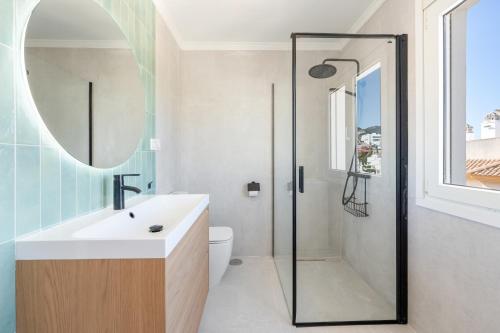 a bathroom with a shower and a sink and a toilet at Balcon de Benalmadena Ocean Views in Benalmádena
