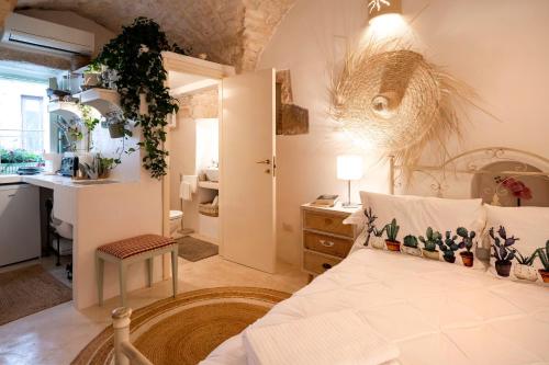 a bedroom with a bed and a bathroom with a sink at Suite Carlomaria in Ceglie in Ceglie Messapica