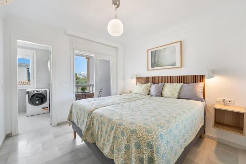 a bedroom with a bed and a television in it at Balcon de Benalmadena Ocean Views in Benalmádena