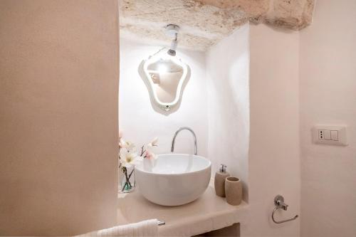a bathroom with a large white bowl sink on a counter at Suite Carlomaria in Ceglie in Ceglie Messapica