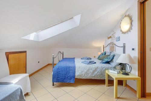 a bedroom with a bed and a table with a lamp at Mansarda di Ponente in Caorle